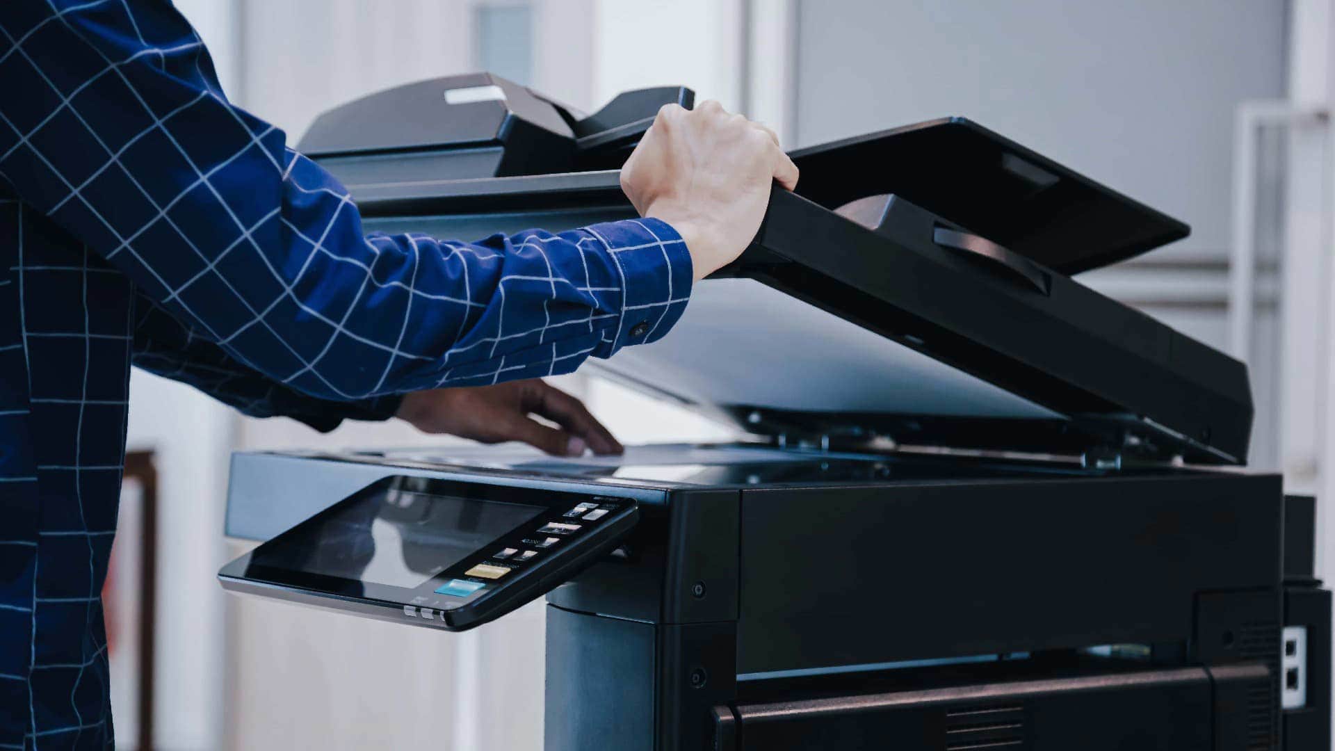 Copier printer close up hand office man press copy button on panel to using the copier or photocopier machine for scanning document printing a sheet paper